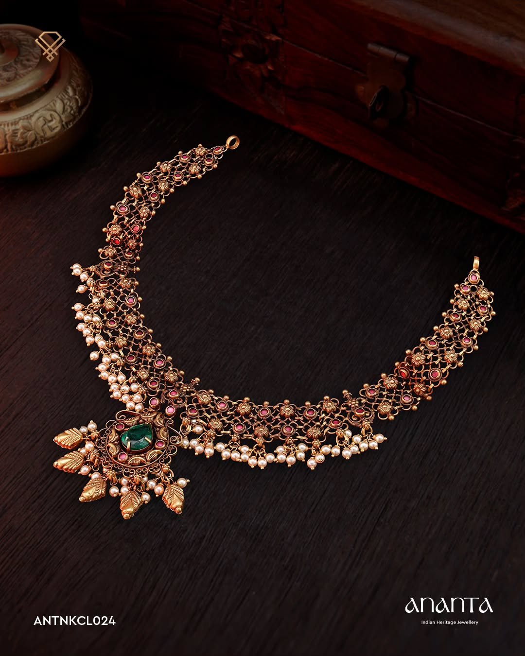 Ananta antique gold heritage necklace with emerald drops on dark velvet