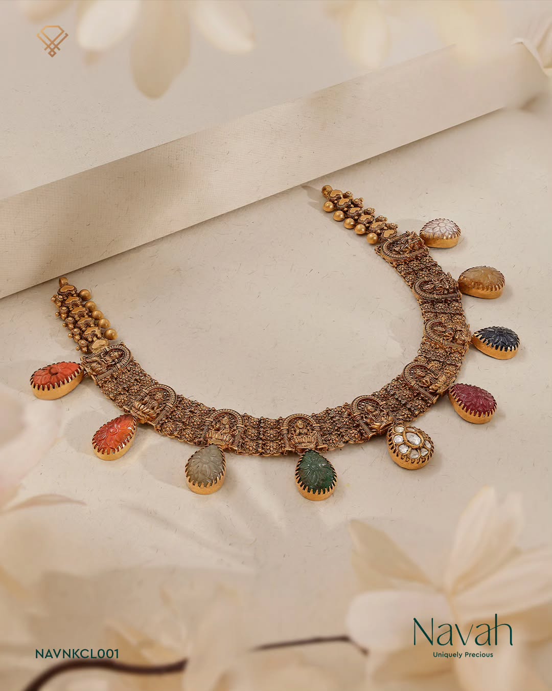 Navah antique gold necklace with carved coloured gem drops on cream paper