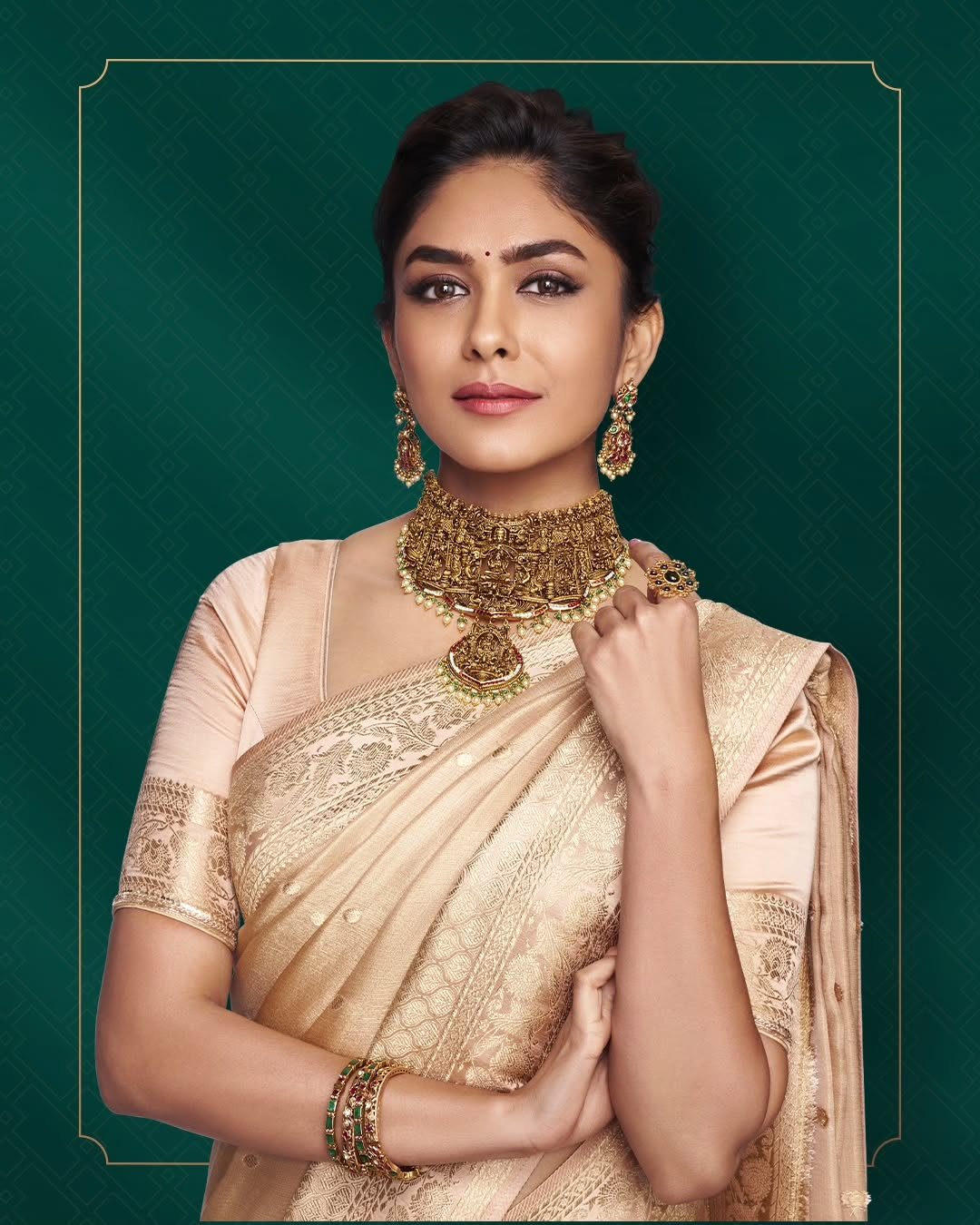 A Meralda muse in a champagne silk saree wearing an antique-gold emerald choker, photographed for the house